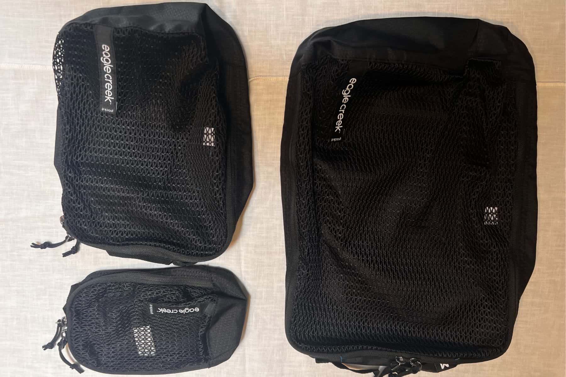 Flat lay of the Eagle Creek Pack-It Reval Cube Set, a three-piece packing cube set.